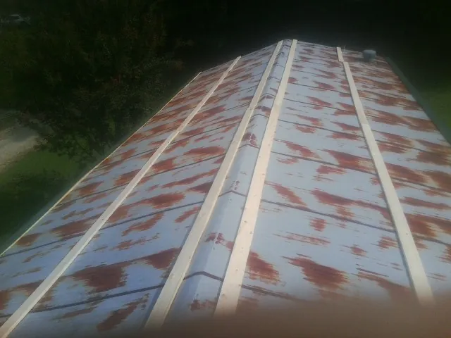 Rusted metal roof panels with new wood purlins before replacement — Storm Damage Roof Repair in Easley by Roofing Brothers