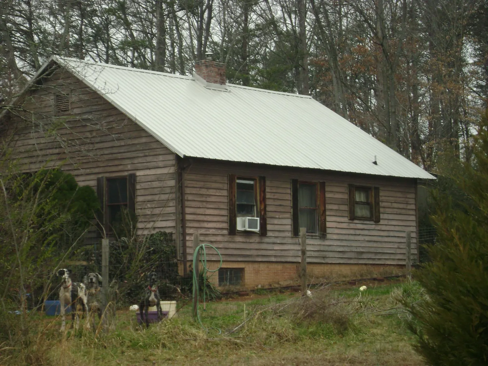 White metal roof on an old wood sided farmhouse, from a Metal Roof Installation job in Easley